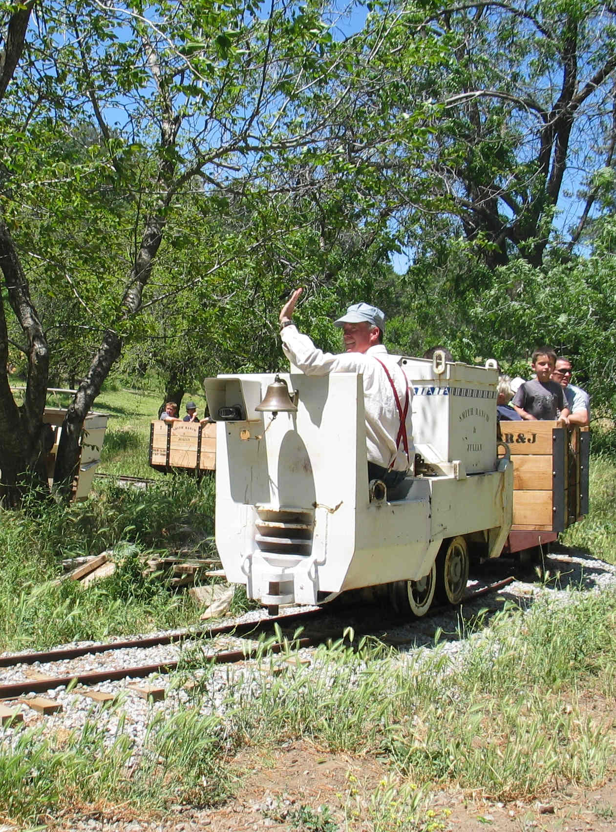 Author Gregory O. Smith driving a battery-powered Gold Mining Locomotive, pulling passengers in train cars, during his popular and successful living history adventure tour program.