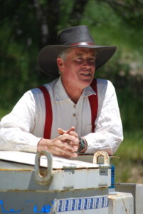 Author Greg Smith speaking from mining locomotive during tour